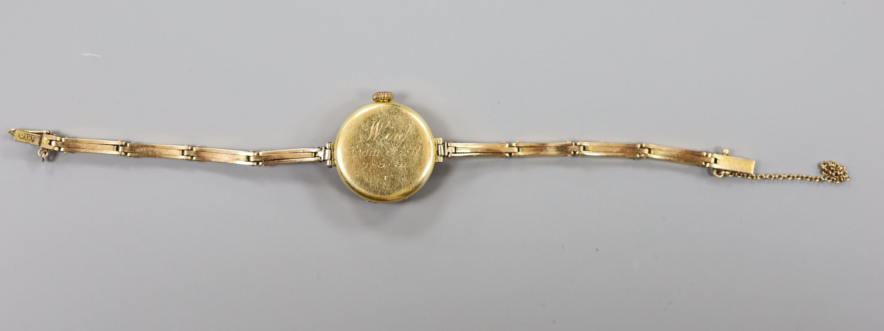 A lady's early 1920's 18ct gold Rolex manual wind wrist watch, with case back inscription, on a flexible yellow metal bracelet stamped 'W15D', case diameter 23mm, length 16.3cm, gross weight 20 grams.